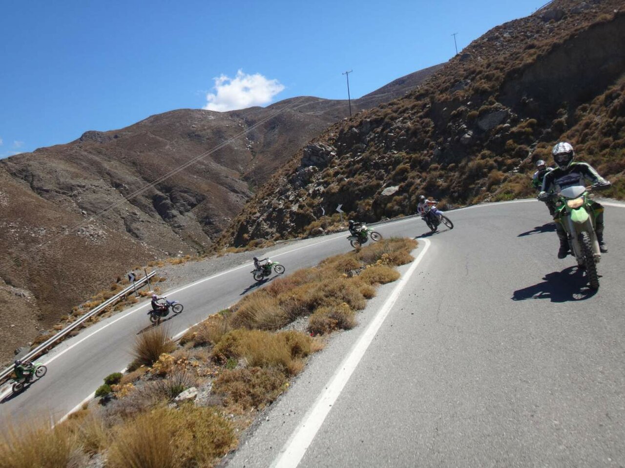 Eine Gruppe Motorradfahrer fährt auf einer kurvigen Bergstraße auf Kreta