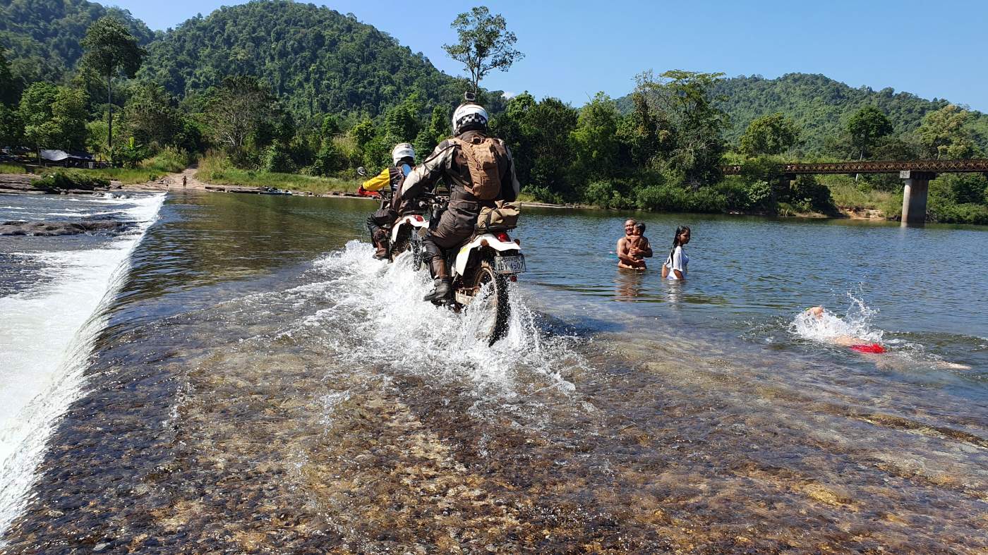 Baden oder Motorradfahren? An manchen Stellen, wie hier in Kambodscha, ist beides nebeneinander möglich.